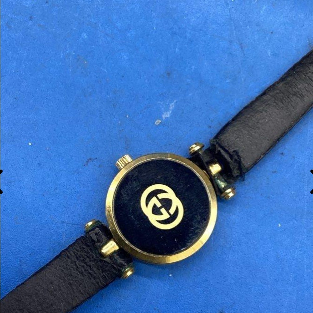 Vintage Gucci Gold Black Tone Watch with Leather Strap.